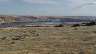 DX0001_019_020 - 5.7K aerial stock footage fly over cliff toward Miller Island and the Columbia River in Goldendale, Washington