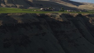 DX0001_019_027 - 5.7K aerial stock footage fly over cliff and vineyard toward the Maryhill Winery in Goldendale, Washington
