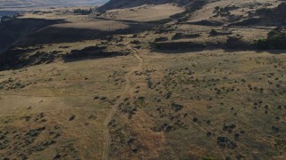 DX0001_019_029 - 5.7K aerial stock footage of following a dirt road through brush in Goldendale, Washington