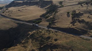 DX0001_019_031 - 5.7K aerial stock footage of a big rig traveling on Lewis and Clark Highway in Goldendale, Washington