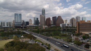 DX0002_102_002 - 5.7K aerial stock footage the city's skyline while passing First Street Bridge and Lady Bird Lake, Downtown Austin, Texas