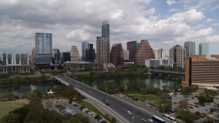 DX0002_102_003 - 5.7K aerial stock footage ascend by First Street Bridge and Lady Bird Lake with view of skyline, Downtown Austin, Texas