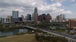 DX0002_102_004 - 5.7K aerial stock footage slowly pass First Street Bridge and Lady Bird Lake with view of skyline, Downtown Austin, Texas