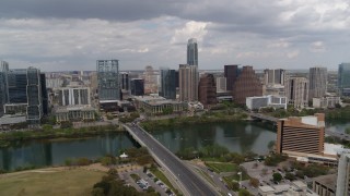 DX0002_102_006 - 5.7K aerial stock footage of First Street Bridge spanning Lady Bird Lake with view of skyline, Downtown Austin, Texas