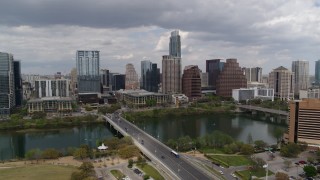 DX0002_102_011 - 5.7K aerial stock footage descend near First Street Bridge and Lady Bird Lake with view of skyline, Downtown Austin, Texas
