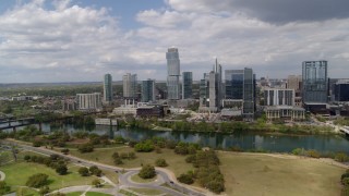 DX0002_102_012 - 5.7K aerial stock footage of a view of city skyscrapers across Lady Bird Lake, Downtown Austin, Texas