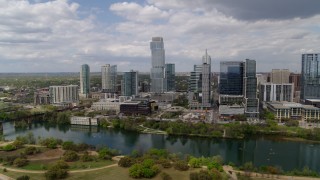 DX0002_102_013 - 5.7K aerial stock footage of a reverse view of city skyscrapers across Lady Bird Lake, Downtown Austin, Texas
