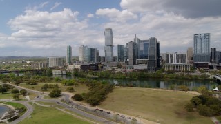 DX0002_102_014 - 5.7K aerial stock footage of a view of city skyline across Lady Bird Lake during descent, Downtown Austin, Texas