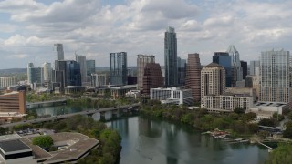 DX0002_102_018 - 5.7K stock footage aerial video approach the city skyline from Lady Bird Lake and ascend, Downtown Austin, Texas