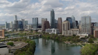 DX0002_102_019 - 5.7K stock footage aerial video of flying away from the city skyline from Lady Bird Lake, Downtown Austin, Texas