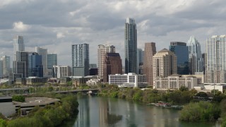 DX0002_103_002 - 5.7K aerial stock footage fly away from skyscrapers, descend toward Lady Bird Lake in Downtown Austin, Texas