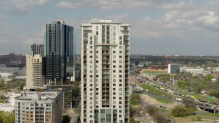 DX0002_103_009 - 5.7K aerial stock footage of orbiting a high-rise apartment building in Downtown Austin, Texas