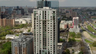 DX0002_103_011 - 5.7K aerial stock footage of circling a high-rise apartment building in Downtown Austin, Texas