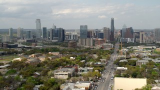 DX0002_103_022 - 5.7K aerial stock footage of flying near Congress Avenue with view of the city's skyline in Downtown Austin, Texas