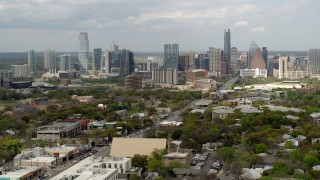 DX0002_103_026 - 5.7K aerial stock footage approach and ascend near Congress Avenue leading to city's skyline in Downtown Austin, Texas