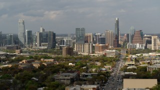 DX0002_103_030 - 5.7K aerial stock footage of Congress Avenue leading to the city's skyline and state capitol in Downtown Austin, Texas