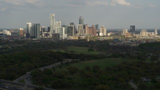 DX0002_104_024 - 5.7K aerial stock footage of a wide view of city's towering skyline, seen from freeway, Downtown Austin, Texas