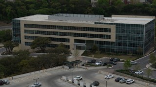 DX0002_104_027 - 5.7K aerial stock footage of reverse view of a modern office building in Austin, Texas