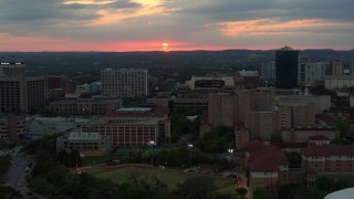 DX0002_105_025 - 5.7K aerial stock footage of the setting sun while descending near the university, Austin, Texas