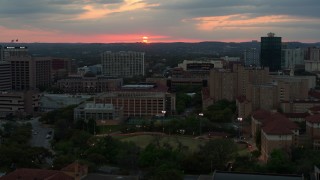 DX0002_105_026 - 5.7K aerial stock footage of the setting sun while flying near the university, Austin, Texas