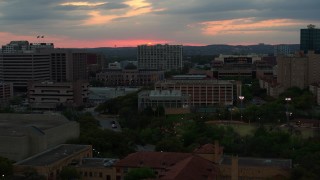 DX0002_105_027 - 5.7K aerial stock footage of the setting sun while passing near the university, Austin, Texas