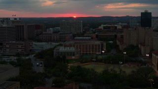 DX0002_105_032 - 5.7K aerial stock footage slowly passing by the university campus with setting sun in distance, Austin, Texas