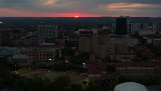 DX0002_105_033 - 5.7K aerial stock footage flyby the university campus with setting sun in distance, Austin, Texas
