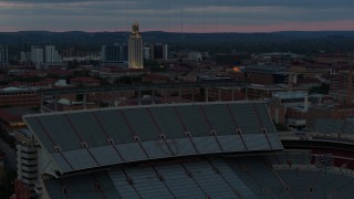 DX0002_105_036 - 5.7K aerial stock footage of UT Tower and football stadium at the University of Texas at twilight, Austin, Texas