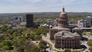 DX0002_107_004 - 5.7K aerial stock footage of orbiting the Texas State Capitol and grounds in Downtown Austin, Texas