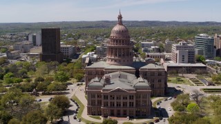 DX0002_107_005 - 5.7K aerial stock footage of orbiting the side of Texas State Capitol and grounds in Downtown Austin, Texas