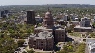 DX0002_107_007 - 5.7K aerial stock footage of approaching the side of Texas State Capitol during ascent in Downtown Austin, Texas