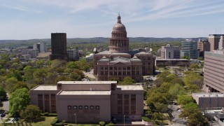 DX0002_107_012 - 5.7K aerial stock footage descend behind library with view of Texas State Capitol in Downtown Austin, Texas