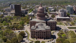 DX0002_107_014 - 5.7K aerial stock footage of flying away from the Texas State Capitol dome in Downtown Austin, Texas