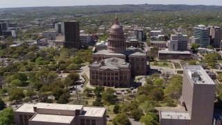 DX0002_107_015 - 5.7K aerial stock footage of a wide orbit around the Texas State Capitol dome and grounds in Downtown Austin, Texas