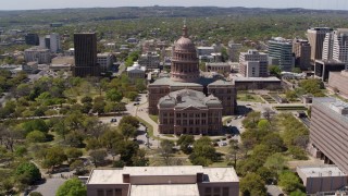 DX0002_107_016 - 5.7K aerial stock footage of orbiting around the Texas State Capitol dome and grounds in Downtown Austin, Texas