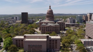 DX0002_107_019 - 5.7K aerial stock footage reverse view of Texas State Capitol, reveal library in Downtown Austin, Texas