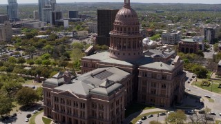 DX0002_107_021 - 5.7K aerial stock footage orbit the Texas State Capitol building before flying away in Downtown Austin, Texas