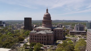 DX0002_107_027 - 5.7K aerial stock footage flying around the side of the Texas State Capitol, Downtown Austin, Texas