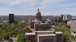 DX0002_107_028 - 5.7K aerial stock footage fly away from Texas State Capitol, descend near library, Downtown Austin, Texas