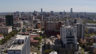 DX0002_107_041 - 5.7K aerial stock footage ascend from the University of Texas for view of skyline of Downtown Austin, Texas