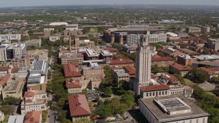 DX0002_107_043 - 5.7K aerial stock footage of slowly flying by campus buildings and UT Tower at the University of Texas, Austin, Texas