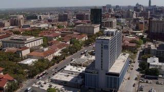 DX0002_107_047 - 5.7K stock footage aerial video of slowly flying by dormitory near campus buildings at the University of Texas, Austin, Texas
