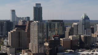 DX0002_108_032 - 5.7K aerial stock footage of The Austonian towering over high-rise hotel and city buildings in Downtown Austin, Texas