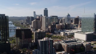 DX0002_108_041 - 5.7K aerial stock footage of a view of the towering city skyline while ascending in Downtown Austin, Texas