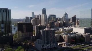 DX0002_108_043 - 5.7K aerial stock footage of towering city skyline while flying between high-rise and hotel in Downtown Austin, Texas