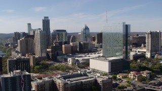 DX0002_108_048 - 5.7K aerial stock footage ascend to focus on hotel and the city's skyline in Downtown Austin, Texas