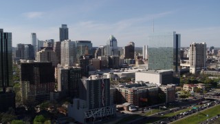 DX0002_108_050 - 5.7K aerial stock footage of a high-rise hotel and the city's skyline, and descend in Downtown Austin, Texas