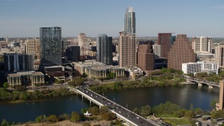 DX0002_109_002 - 5.7K aerial stock footage of the city's skyline across Lady Bird Lake seen from bridge, Downtown Austin, Texas