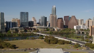 DX0002_109_003 - 5.7K aerial stock footage of the city's skyline on the opposite side of Lady Bird Lake seen from bridge, Downtown Austin, Texas