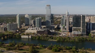DX0002_109_005 - 5.7K aerial stock footage modern skyscraper across Lady Bird Lake, Downtown Austin, Texas